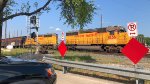 Two SD40-2s lead a train off the Neches River Lift Bridge